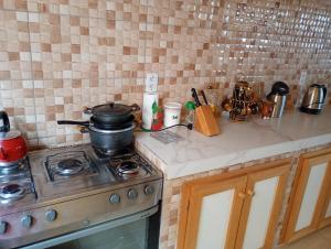 a kitchen with a stove with a pot on it at Casa sobrado in Alegrete