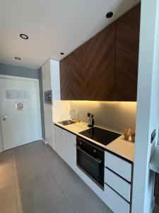a kitchen with a sink and a stove at BW LUX STUDIO-Belgrade Waterfront in Belgrade