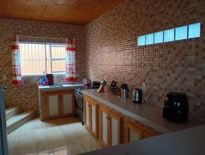 a kitchen with a stove and a counter top at Casa sobrado in Alegrete