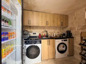 a kitchen with a washing machine and a refrigerator at Mirisso Konağı MARDİN in Mardin