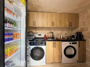 a kitchen with a washing machine and a refrigerator at Mirisso Konağı MARDİN in Mardin +19 photos