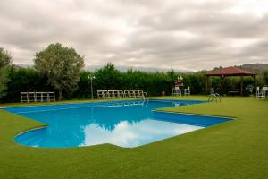 a swimming pool in a yard with a gazebo at La Cassola del Priorat in Gratallops