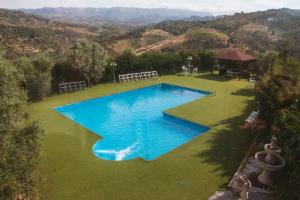 an overhead view of a blue swimming pool in a field at La Cassola del Priorat in Gratallops +10 photos