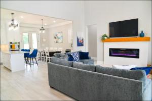 a living room with two couches and a kitchen and a living room with at Luxe Dream Beach House in Gulfport