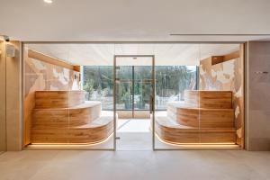 a three tiered wedding cake in a room with glassdoors at Tavel Hotel & SPA in Bukovel