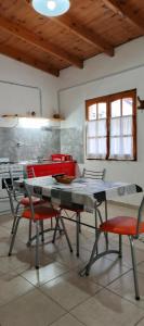 a dining room with a table and chairs in a room at Palo Blanco in Cinco Saltos