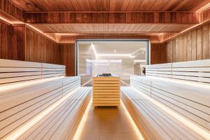 a sauna with wooden walls and white beds at Tavel Hotel & SPA in Bukovel