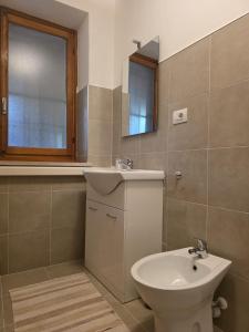 a bathroom with a sink and a toilet and a mirror at L'Albore in Costigliole Saluzzo +26 photos