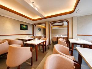 a dining car of a train with tables and chairs at The Signature Munnar in Munnar