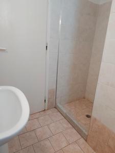 a bathroom with a shower and a sink at Deilino - Side View Studio in Amorgos +1 photo