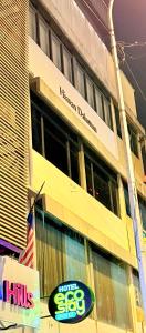 a high rise building with a sign on it at Hotel EcoStay at Chow kit in Kuala Lumpur