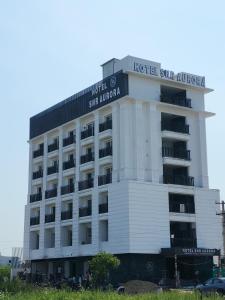 a hotel building with a sign on top of it at HOTEL SNR AURORa in Guntūr