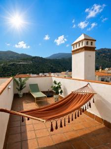 a hammock on the roof of a house at Casa Velez in Vélez de Benaudalla
