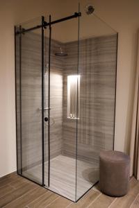 a glass shower with a stool in a room at Kruja Gate in Krujë +62 photos
