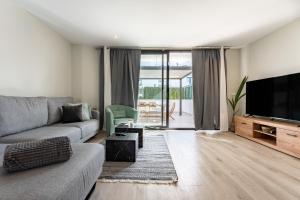 a living room with a couch and a flat screen tv at Casa Miramar Oak 47 in Fuengirola