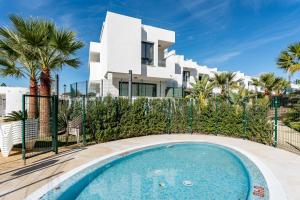 a villa with a swimming pool in front of a house at Casa Miramar Oak 47 in Fuengirola