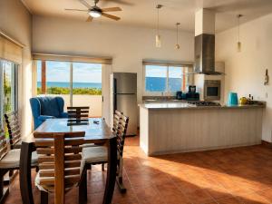 a kitchen and dining room with a table and chairs at Hotel Yaltas Inn in Tola +10 photos