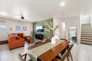 a living room with a table and a couch at Stylish 4BR Escape Open Layout Smart TVs A in El Paso