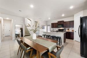 a kitchen and dining room with a table and chairs at Stylish 4BR Escape Open Layout Smart TVs A in El Paso
