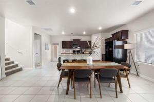 a kitchen and dining room with a table and chairs at Stylish 4BR Escape Open Layout Smart TVs A in El Paso