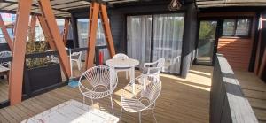 a patio with chairs and a table on a deck at Casa Hotel Trocha Angosta in Constitución