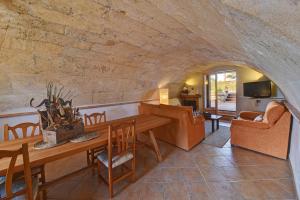 Una sala de estar con una mesa de madera y un sofá. en Finca Hort De Sa Barrala, en Ses Covetes