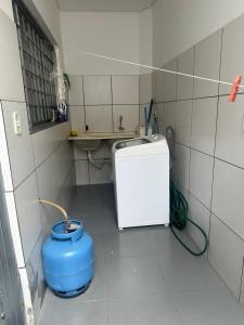 a small bathroom with a sink and a blue bucket at Ap 07 mazzonetto in Primavera do Leste