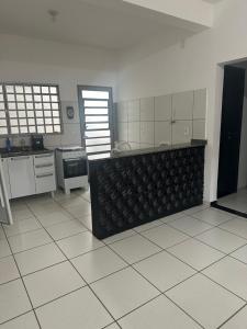 a kitchen with a counter in the middle of a room at Ap 07 mazzonetto in Primavera do Leste
