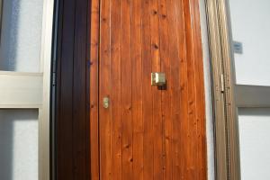 a wooden door with a metal knocker on it at Casa Argi in Camerano +28 photos