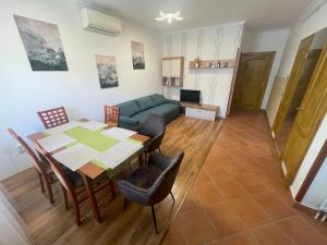a living room with a table and a couch at Kosbor apartman in Igricetanya