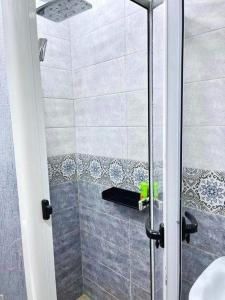 a shower with a glass door in a bathroom at Las Brisas Beachfront Mekad private in Oued Laou +33 photos