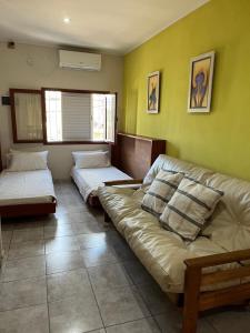 a living room with two beds and a couch at El Buen Descanso in Gualeguaychú