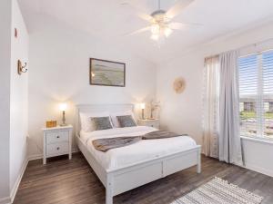 a white bedroom with a bed and a window at Convenient & Inviting - Fully-Equipped 2BD Condo in Gainesville