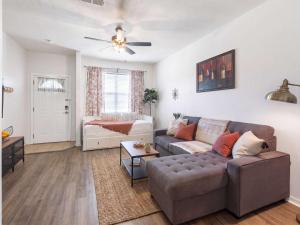 a living room with a couch and a table at Convenient & Inviting - Fully-Equipped 2BD Condo in Gainesville
