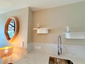a bathroom with a sink and a mirror at Escale élégante à la mer Duplex neuf en front de mer in Bénodet +24 photos