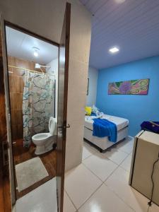 a bathroom with a shower and a toilet and a bed at Hostel 4 Cantos in Olinda