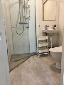 a bathroom with a shower and a sink at Sköna Rum Fryksta in Kil +73 photos