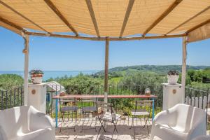 a patio with a table and chairs and a view at La collina sui trabocchi in Ortona +23 photos