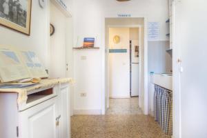 a kitchen with white cabinets and a hallway at La collina sui trabocchi in Ortona