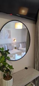 a mirror in a room with a bedroom at House Kiriaki in Sarti