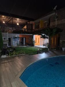 a swimming pool in a backyard at night at Villa Miradie in Grand-Bassam