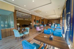 a restaurant with blue chairs and tables and blue chairs at Erbil Quartz Hotel in Erbil