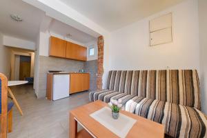 a living room with a couch and a table at FIRST ROW Sea View in Šušanj