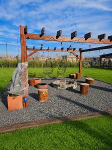 a park with a wooden pergola and a playground at Don Vito Casa de Huespedes in Cucullú