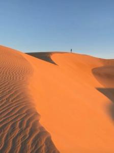 a person standing on top of a sand dune at Apartamento Império das Marés in Paracuru