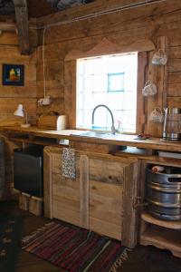 a kitchen with a sink and a window at Agroturystyka Lasy Północy Leśna Chata in Dzierniakowo +24 photos