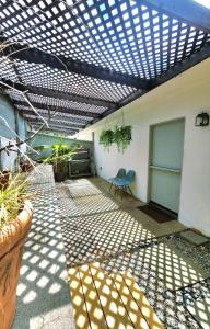 a patio with a roof with a table and a chair at 30 PCT OFF!! Limited Time! Malibu Ocean Wave with King Bed, Walking to Beach and Hiking in Malibu