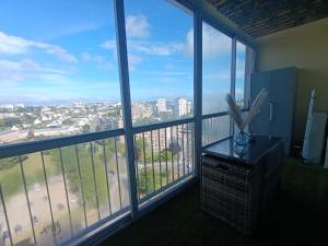 a room with large windows with a view of a city at Vannes in Brest