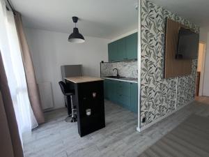 a kitchen with blue cabinets and a sink and a desk at Vannes in Brest