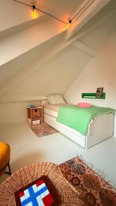a room with a bed in a attic at Asanzo Historic Attic-Traditional Norwegian Home & Warm Indian Hospitality in Stavanger